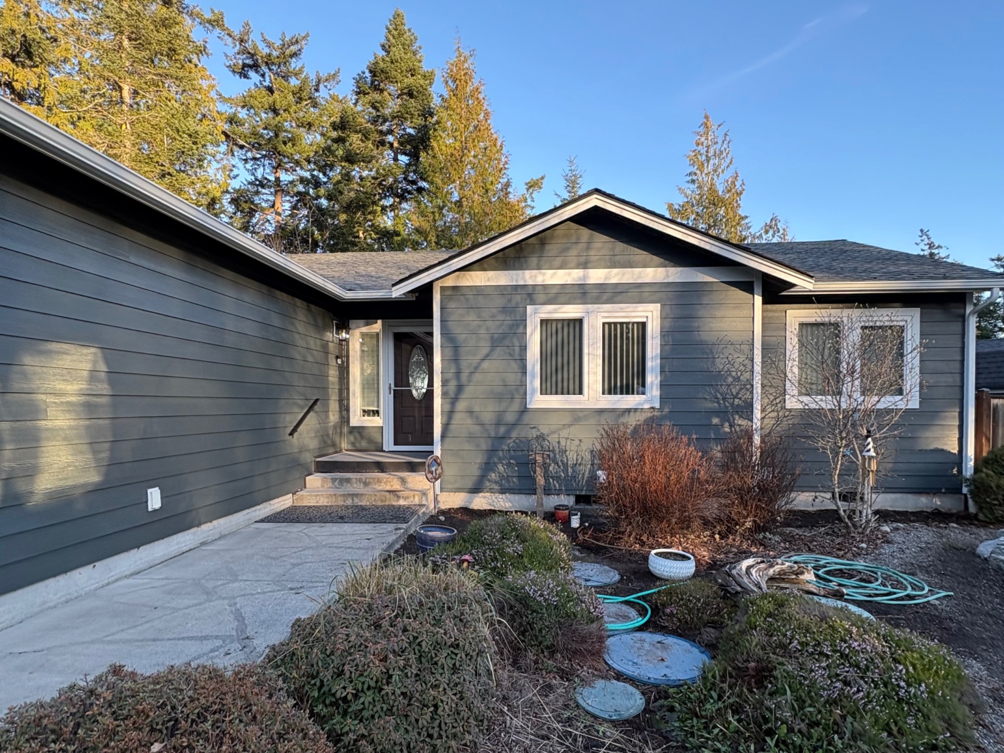 Gray horizontal siding and white trim on a completed home