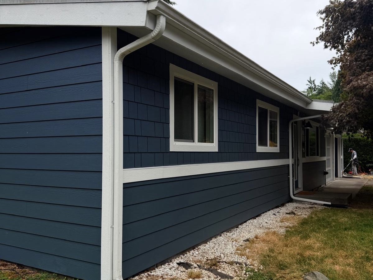 Blue horizontal and shingle siding with white trim
