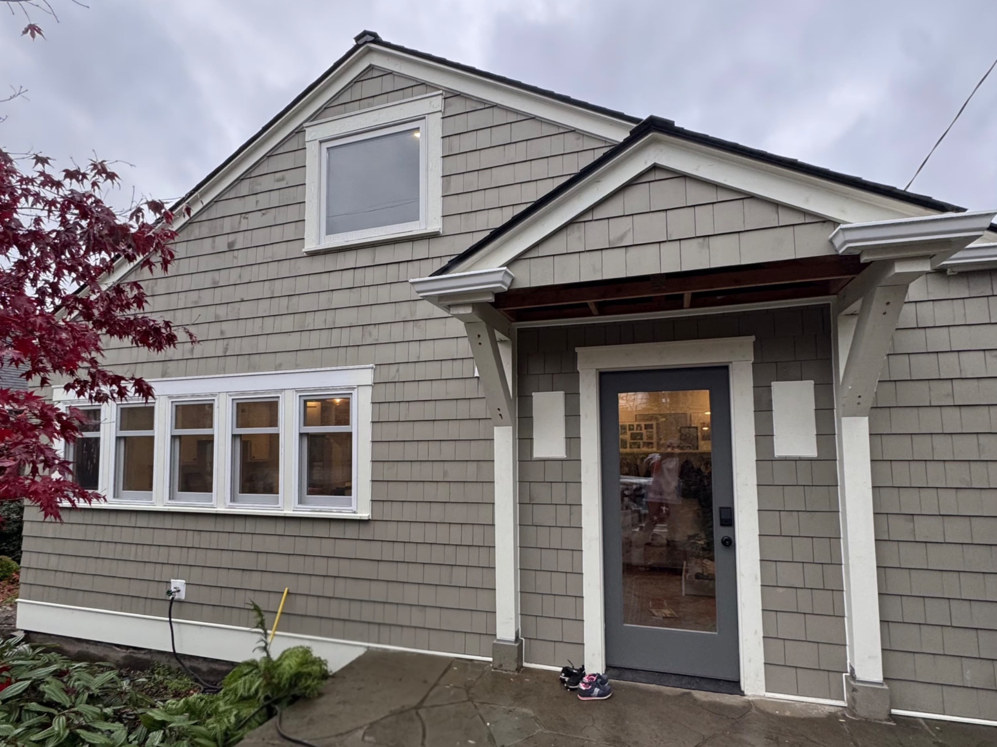 Gray shingle siding and white trim around windows